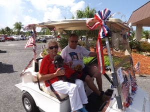 Grand Marshal Izak Kolodny with Corinne Keifer and canine friends Pepe 'le Pew and Cassie leading the parade.