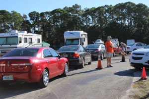 Paul Reed directs traffic as the cars enter the RV Compound to be washed.