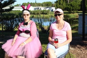 Fairy Princess June Reed (L) and Deb Poe greet La Casa residents as they lineup to have their cars washed.